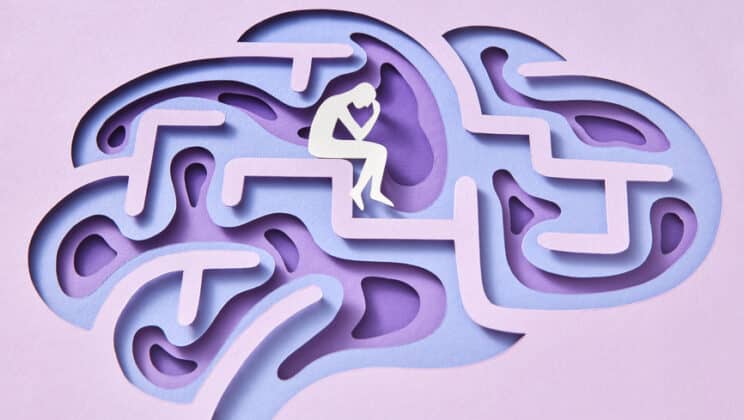 labyrinth of human brain with paper thinker sitting inside on a light lavender background space