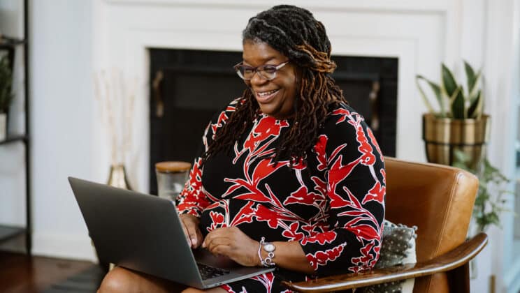 A woman having a virtual therapy session on her laptop.