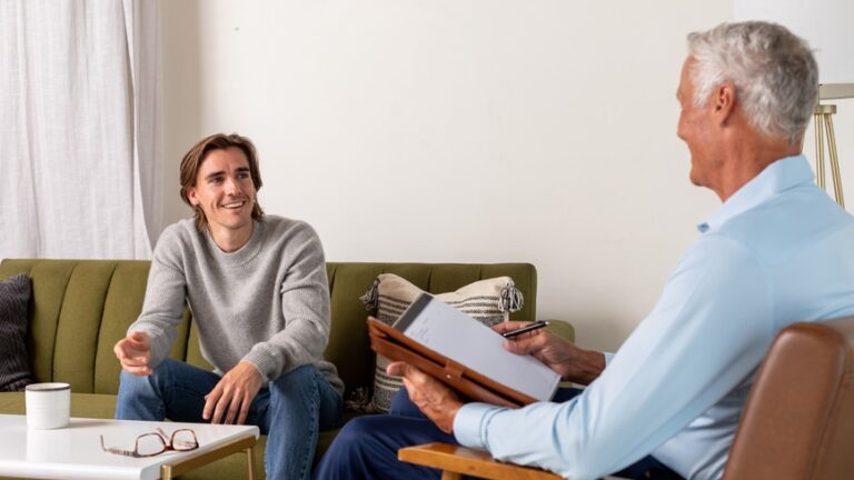 Therapist Takes notes during a session with a male client.