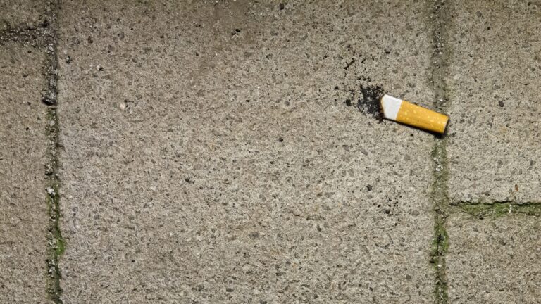 Finished cigarette stub on floor, concept: final cigarette