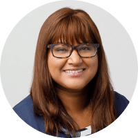 headshot of female provider with red hair and glasses