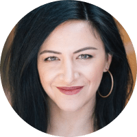 headshot of female provider with black hair and hoop earrings