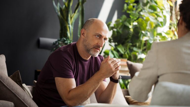 Patient listening to his psychotherapist with concerned look on his face