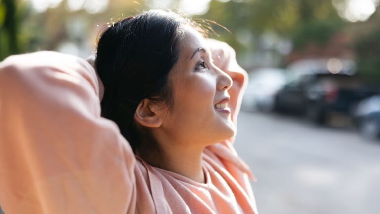 She is relaxed, taking deep breaths and stretching her back.