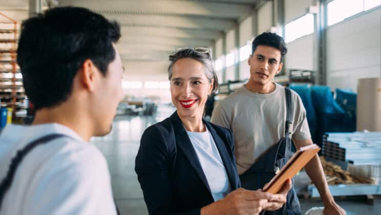 Portrait of woman supervisor showing employees what they should do